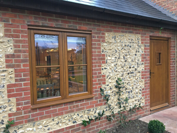 Brown wooden entry door and windows.