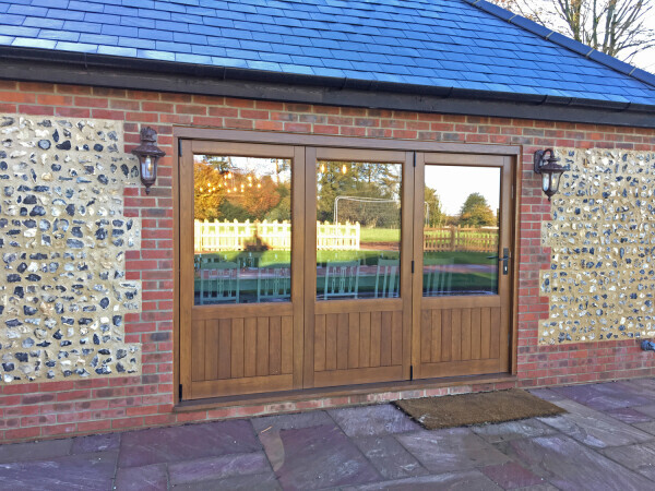 Brown bi-fold doors with glass.