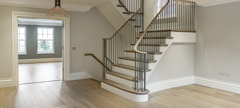 hallway with metal balustrade staircase