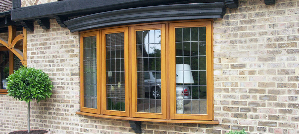 curved timber stormproof window on brick