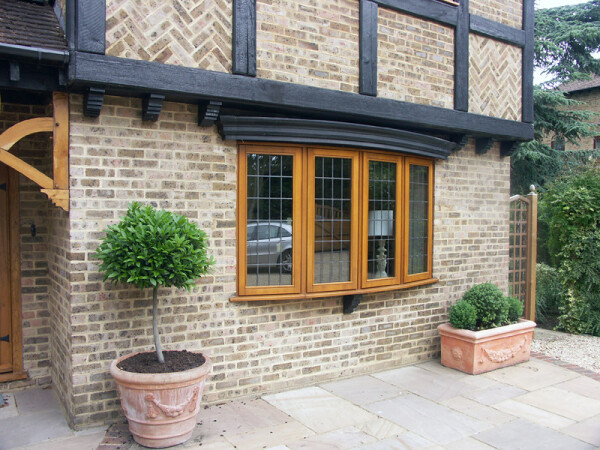curved stormproof window on a Tudor house