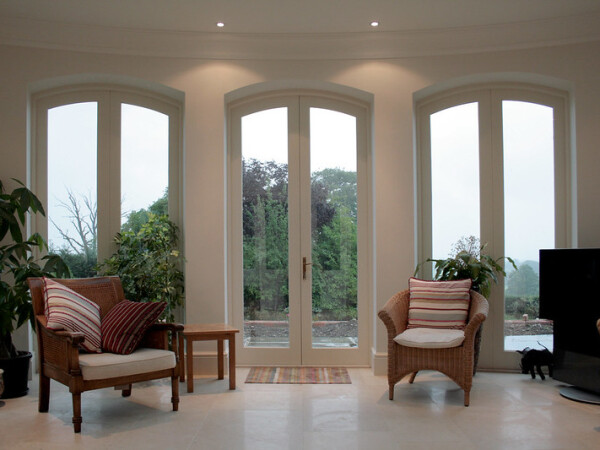 White arched timber french door